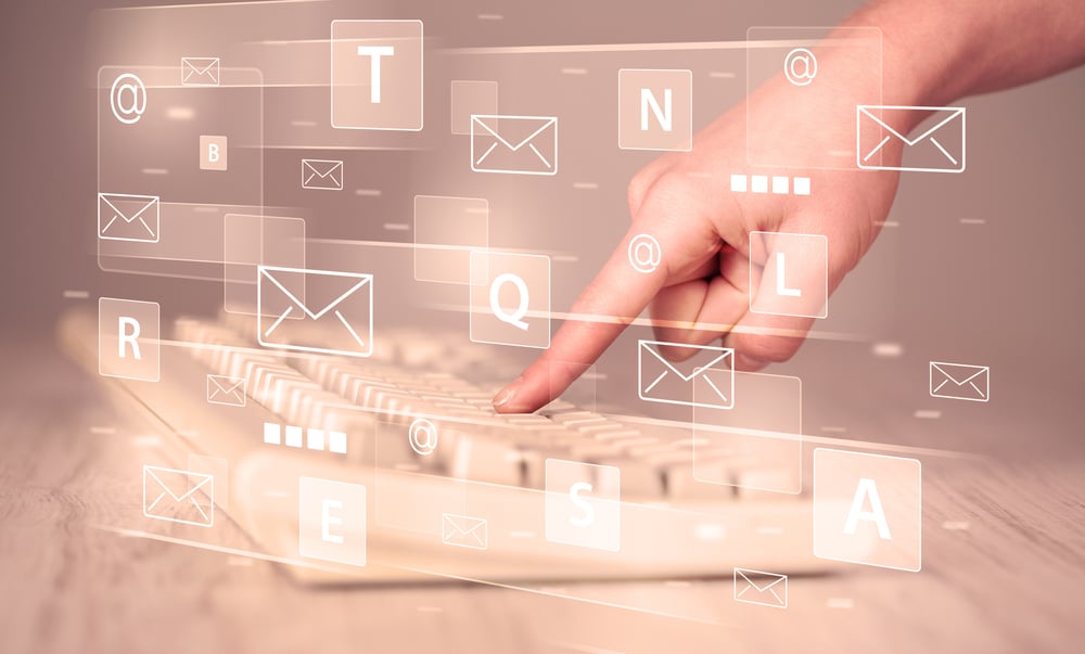 Hand typing on keyboard with digital tech icons and symbols