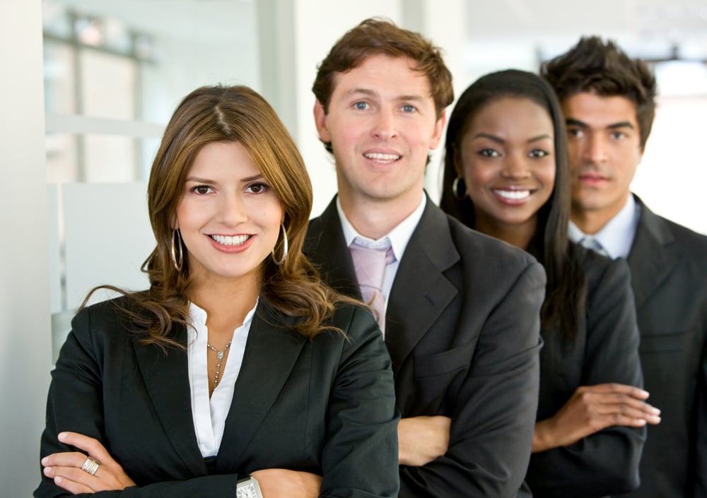 group of business colleagues smiling in an office lined up